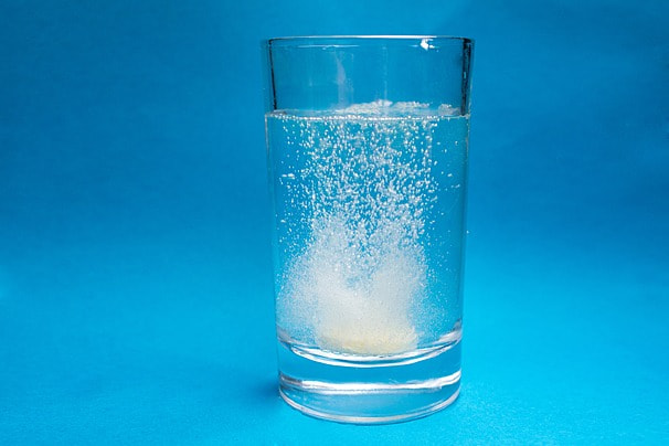 pngtree-effervescent-tablets-produce-bubbles-in-water-image_1064724